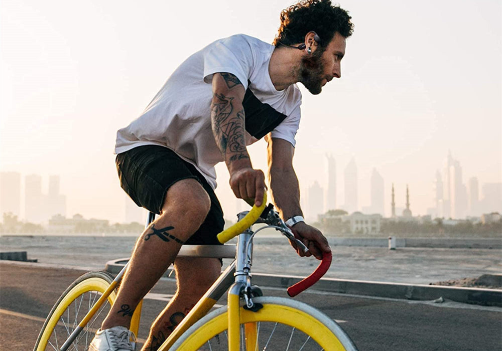 A cyclist rides with bone conduction headphones