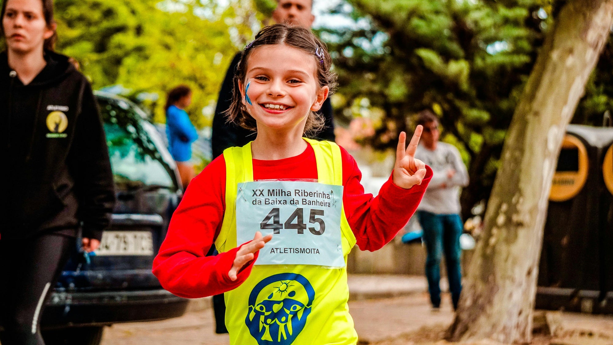 A little girl running a marathon.