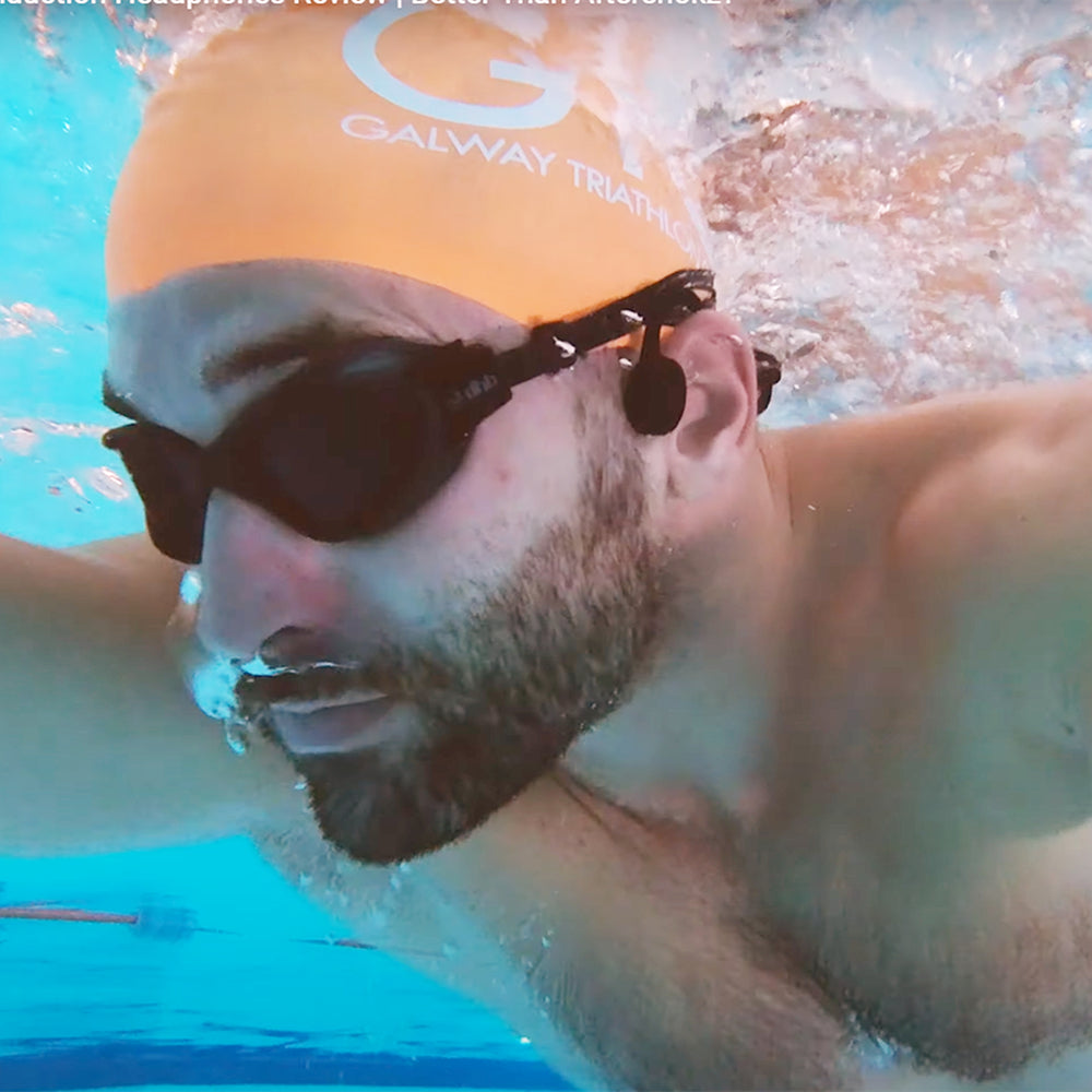A swimmer is swimming wearing bone conduction swimming headphones
